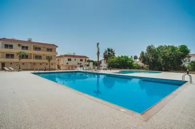 a large swimming pool in front of a building at Apartment Helena in Ayia Napa