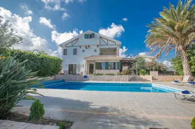 a villa with a swimming pool and a house at Protaras Holiday Villa Jo78 in Paralimni