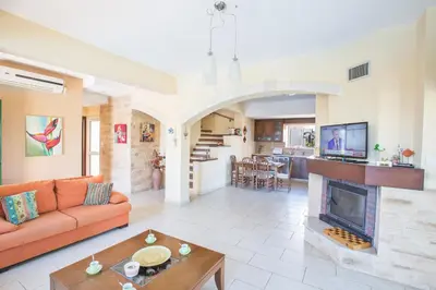 a living room with a couch and a fireplace at Protaras Holiday Villa Jo78 in Paralimni