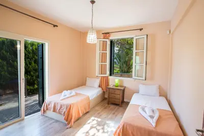two beds in a room with two windows at Protaras Holiday Villa Jo78 in Paralimni