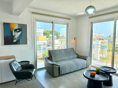 a living room with a couch and a chair at Vacation mode Apartment in Ayia Napa