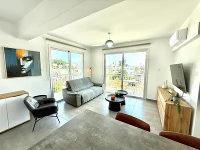 a living room with a couch and a table at Vacation mode Apartment in Ayia Napa