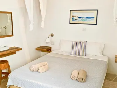 a bedroom with a bed with towels on it at Palatakia - Adults Only in Kato Drys