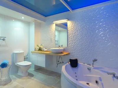 a bathroom with a tub and a sink and a toilet at Palatakia - Adults Only in Kato Drys