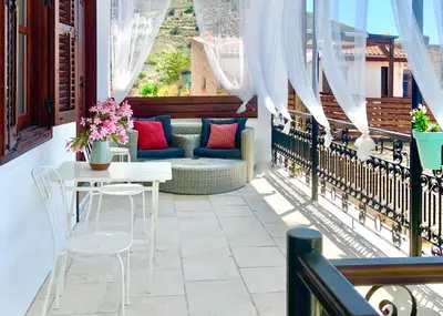 a patio with a table and chairs on a balcony at Palatakia - Adults Only in Kato Drys