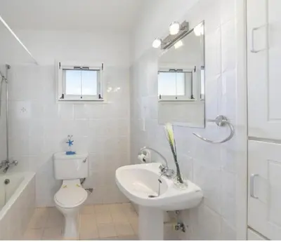 a white bathroom with a toilet and a sink at Protaras Fig Tree Bay Sea View Villa , Jacuzzi Available April to October in Protaras
