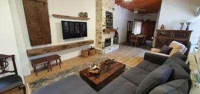 a living room with a couch and a fireplace at Bougainvillea House Lefkara in Pano Lefkara