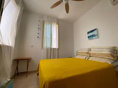 a bedroom with a yellow bed and a window at Zoe's villa by Turtle Bay in Protaras