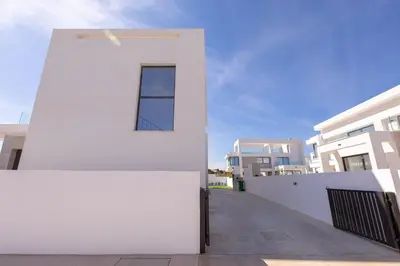 a white building with a window on the side of it at Nelia Panorama Villa in Protaras