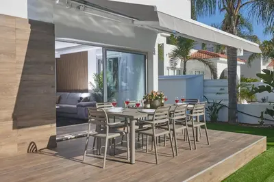 a patio with a table and chairs on a deck at Sunrise Villa 9 in Ayia Napa