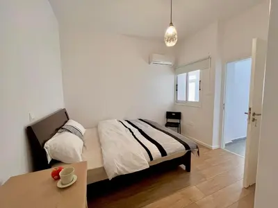 a bedroom with two beds and a table at Stasinou 52 in Limassol