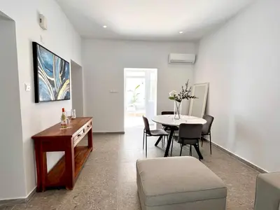 a living room with a table and a table and chairs at Stasinou 52 in Limassol