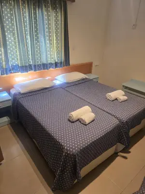 a bedroom with a bed with two towels on it at Eleni Apartments in Ayia Napa
