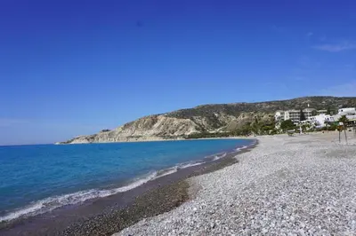 a beach with rocks and the water and buildings at Villa Hanna mit Meerblick in Pissouri