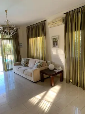 a living room with a couch and a table at Villa 28 Protaras in Protaras