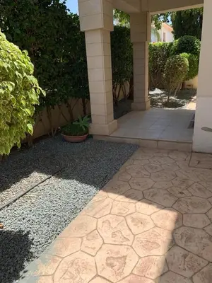 a building with a porch with a stone walkway at Villa 28 Protaras in Protaras