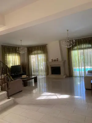 a large living room with a couch and a tv at Villa 28 Protaras in Protaras