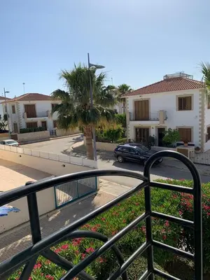 a balcony with a fence and a street with houses at Villa 28 Protaras in Protaras