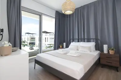 a bedroom with a large white bed and a large window at Villa Selena in Protaras