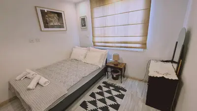 a small bedroom with a bed and a window at STAY Serenity Apartment in Yukarı Lakatamya