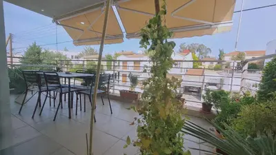 a patio with a table and chairs on a balcony at STAY Serenity Apartment in Yukarı Lakatamya