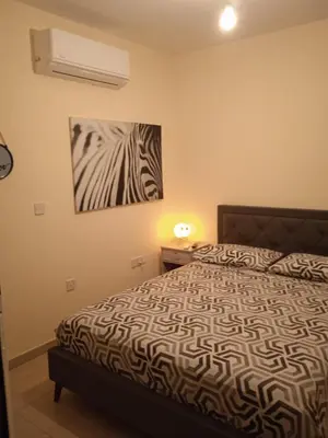 a bedroom with a bed and a painting on the wall at Xylophagou Rest and Relax 2 Ayia Napa Larnaca 1 bedroom apartment in Xylophaghou