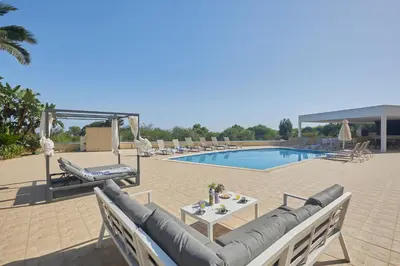a patio with a couch and a table next to a pool at Protaras Holiday Villa Pa7 Private 7 Bedroom villa in Protaras