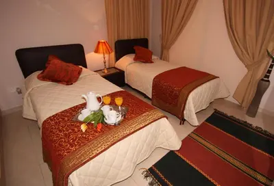 a hotel room with two beds and a tray of food at Three bedroom villa with private pool and landscaped garden close to the beach in Pissouri