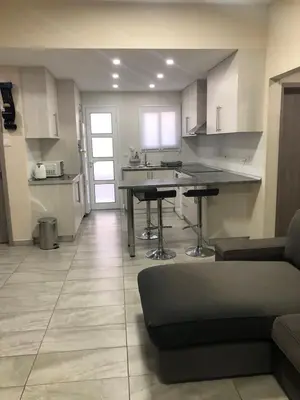 a kitchen with a table and a couch in a room at Great Views Apartment II in Limassol