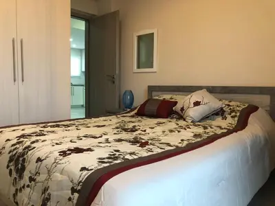 a bedroom with a bed with a comforter on it at Great Views Apartment II in Limassol