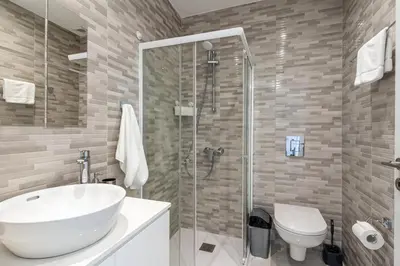 a bathroom with a sink and a shower and a toilet at Lana 1-Bedroom Apt in Larnaca in Larnaka