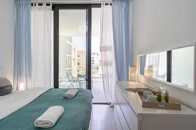 a bedroom with a bed and a desk with towels on it at Lana 1-Bedroom Apt in Larnaca in Larnaka