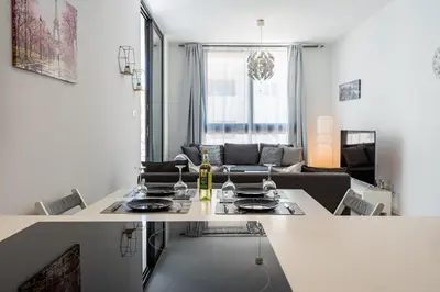 a kitchen and living room with a table and a couch at Lana 1-Bedroom Apt in Larnaca in Larnaka