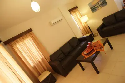 a living room with a couch and a table at A three-bedroom villa with a private pool and landscaped garden Wi-Fi in Pissouri