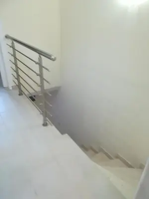 a metal railing on the side of a white wall at Soula Beach House in Protaras