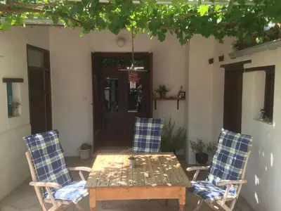 a table and two chairs and a table and a table at Guesthouse Gonia in Pera Orinis