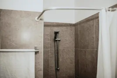 a shower with a shower curtain in a bathroom at Ovis Hotel Apartments in Ayia Napa