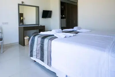 a white bed with towels on it in a room at Napa Jay Hotel in Ayia Napa