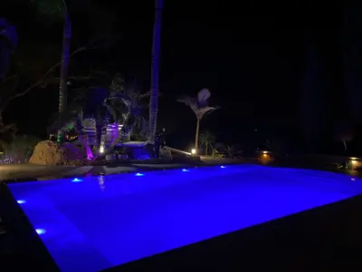 a swimming pool with blue lighting at night at Mediterranean View Villa in Protaras