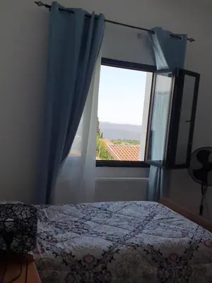 a bedroom with a bed and a window with a view at Indie7house in Pano Lefkara