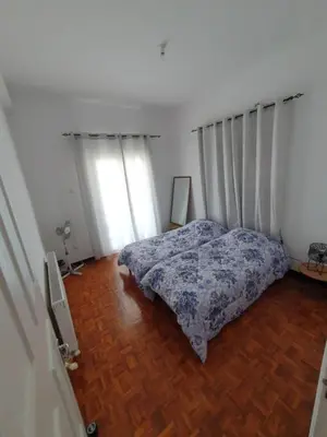 a bedroom with a bed and a wooden floor at Indie7house in Pano Lefkara