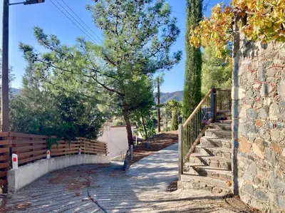 a stairway with a stone wall and a tree at Traditional House with Mountain View - Dierona Village in Dierona