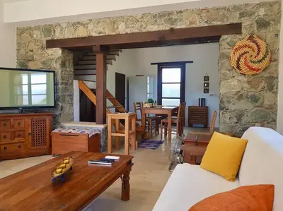 a living room with a white couch and a table at Traditional House with Mountain View - Dierona Village in Dierona