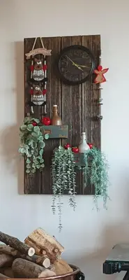a wall with a clock and some plants on it at Stella's Country House in Prodromos