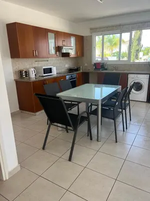 a kitchen with a table and chairs in a kitchen at Chara Cynthiana Villa in Paralimni