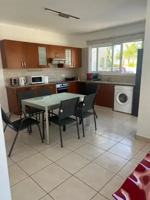 a kitchen with a table and chairs in a room at Chara Cynthiana Villa in Paralimni