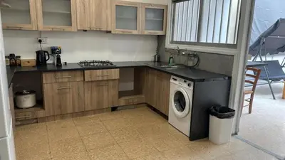 a kitchen with a washer and a washing machine at Unique City Hostel 100 meters from Beach in Larnaka