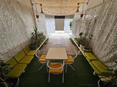 a table and chairs in a room with plants at Unique Sea & City Lifestyle Studio in Limassol