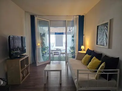 a living room with a couch and a table at Unique Sea & City Lifestyle Studio in Limassol