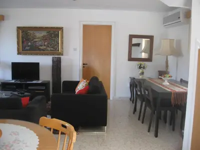 a living room with a table and a dining room at Zena Holiday Villa in Pissouri